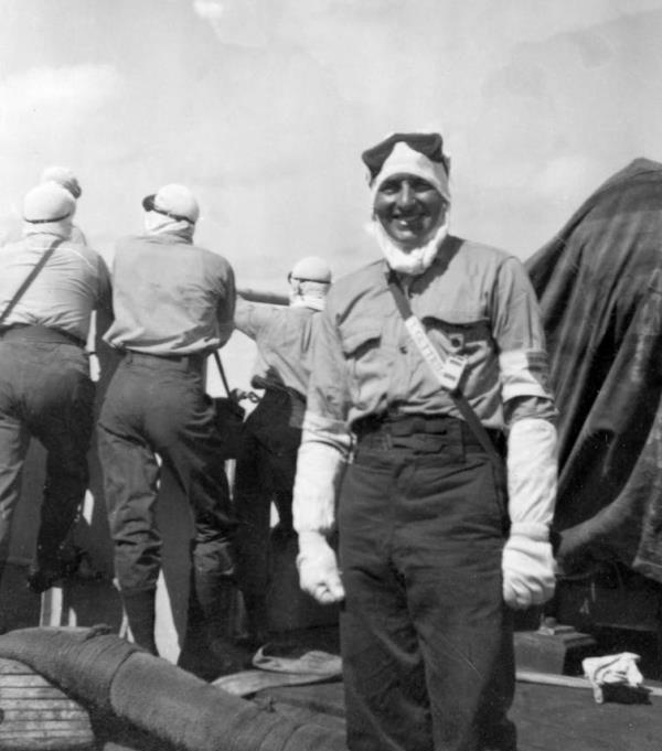 A British naval officer wearing anti-flash clothing during a nuclear test.